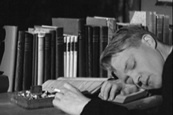 Kuva: Opiskelija poika nukkuu ty�p�yd�n ��rell� tupakka k�dess�. YLE kuvanauha.