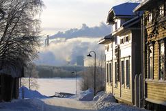 Kuva: Puutaloja ja paperitehtaan savuavia piippuja talvisessa Oulussa. Mika Kanerva / YLE